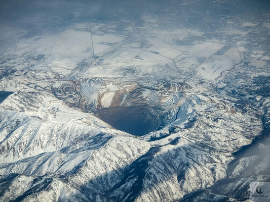Photo by Jay H on Unsplash, Kennecott Copper Mine in Winter, Snowy, from the sky looking down and Northeast.
