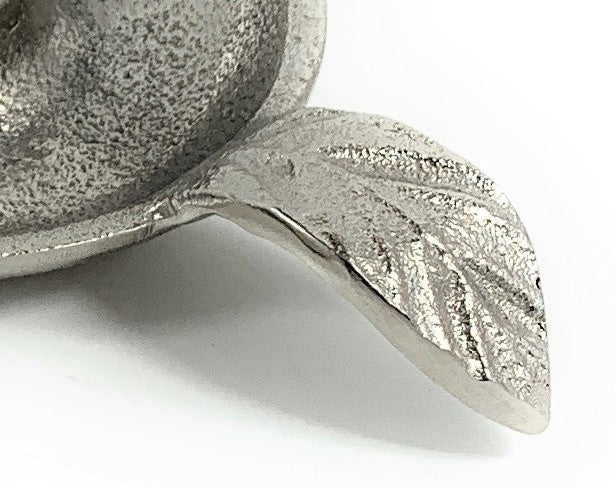 Close-up of the textured silver finish and veined leaf handle