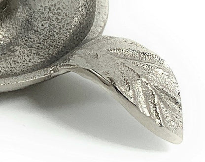 Close-up of the textured silver finish and veined leaf handle