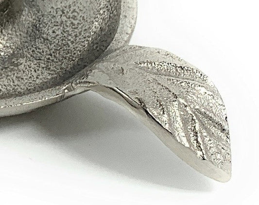 Close-up of the textured silver finish and veined leaf handle