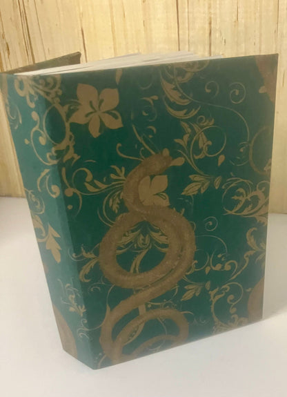 Green journal cover with gold snake and floral motifs