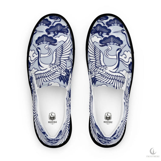 Pair of slip-on shoes with blue and white crane design on a white background