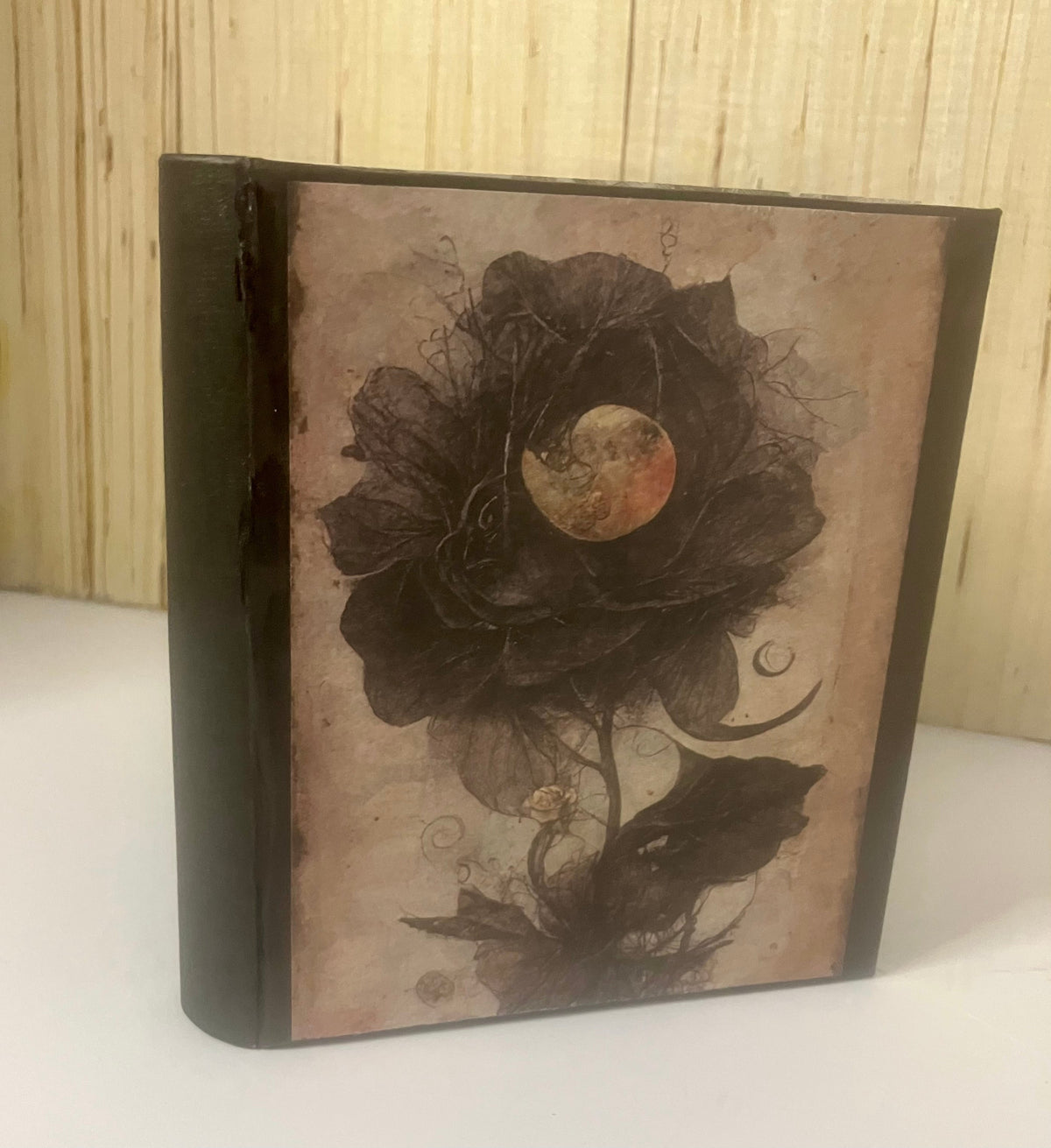 Dark floral journal cover with a moon and bird illustration