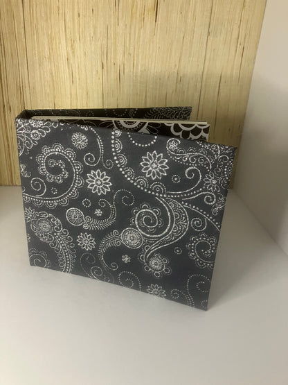 Black and white glitter journal standing open with a paisley-patterned cover