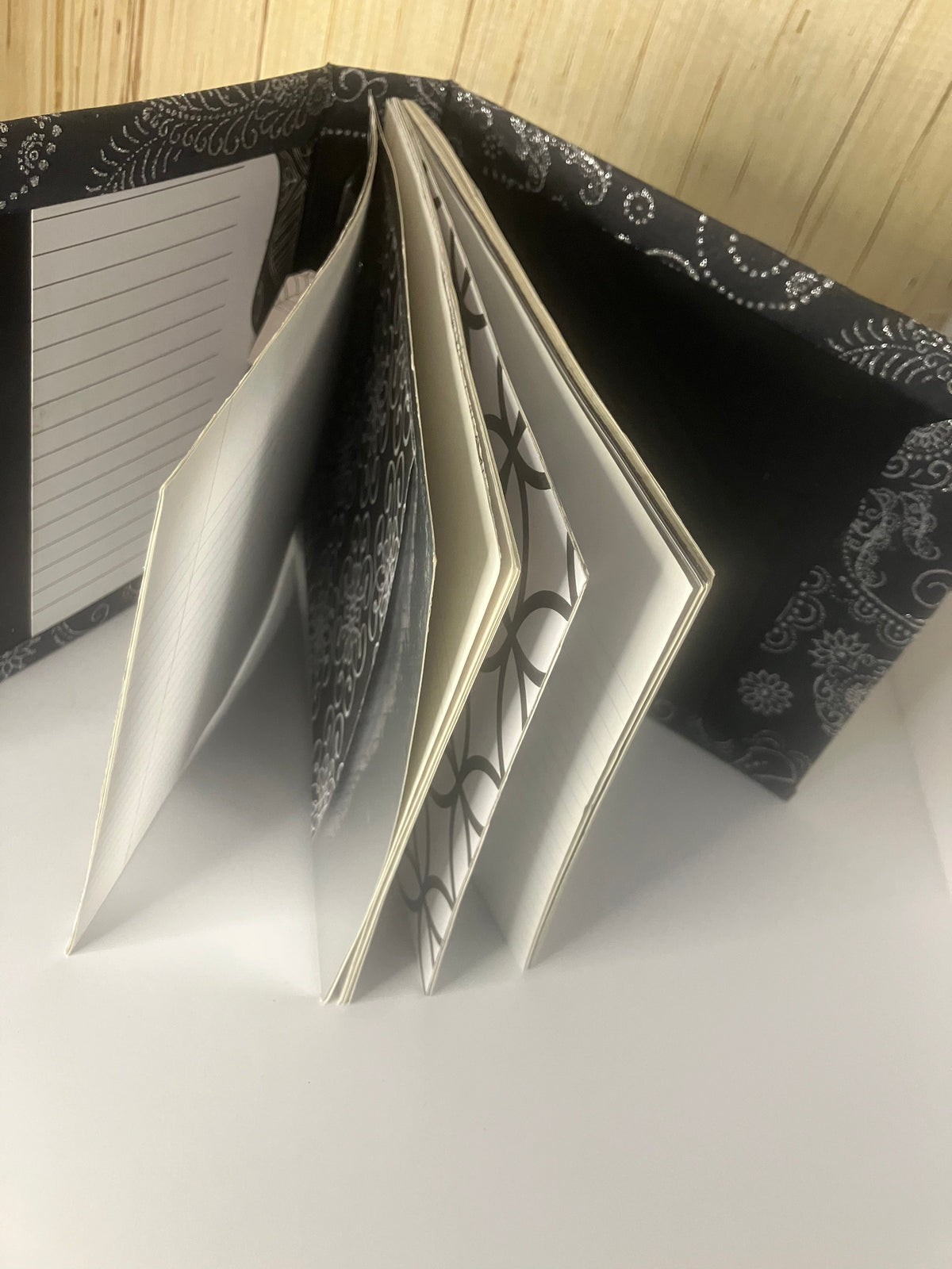 Handbound black and white journal with mixed pages fanned open