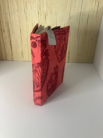 Red anatomical-heart journal viewed from the spine