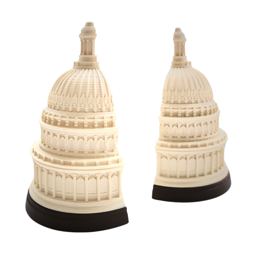 Pair of ivory Capitol dome bookends with dark bases on a white background