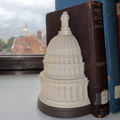 Ivory Capitol dome bookend beside vintage books on a windowsill